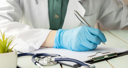 Doctor advising patient in hospital office, medical concept