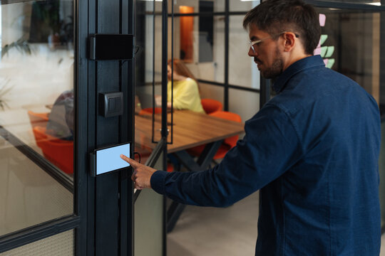 Office worker using touchscreen panel for access control in modern office