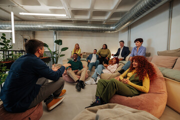 Creative team listening to project manager explaining strategy in modern office
