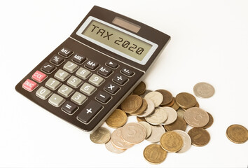 finances, calculator and coins on a bright table