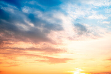 Fototapeta premium Sky,sunset, beautiful , luxury soft gradient orange gold clouds and sunlight on the blue sky perfect for the background, Sunrise on morning or everning in winter warm time ,Twilight summer,silhouette