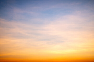 Obraz premium Sky,sunset, beautiful , luxury soft gradient orange gold clouds and sunlight on the blue sky perfect for the background, Sunrise on morning or everning in winter warm time ,Twilight summer,silhouette