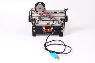 Mini Laser Engraving Machine for Wood on White Background. engraving handmade wood products and...