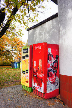 Cappy and Coca Cola drink machines against a wall of a small snack bar in the city center