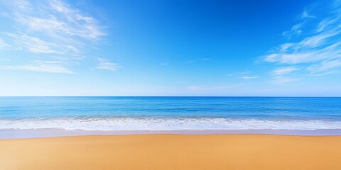 Fototapeta premium Sand on the beach creates a serene atmosphere, complemented by the sea and a blue sky, offering a perfect nature background for those who appreciate the beauty of sandy shores.