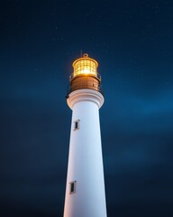 A tall white lighthouse shines brightly against a dark, starry sky, serving as a guiding beacon for ships navigating the night.