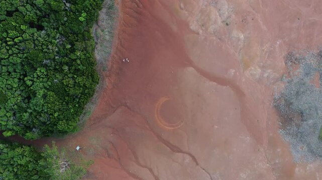 Barreiro da Faneca. A semi-desert, vibrant and clayish landscape, red in colour, it is usually called &ldquo;red desert&rdquo;. Aerial view over moon-like terroir with a couple of friends walking in distance.