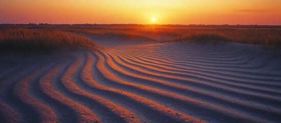 Fototapeta premium Sunset over textured sand dunes.