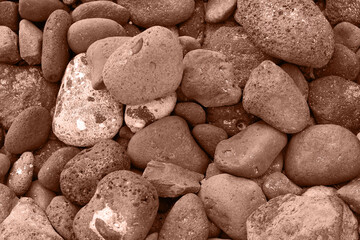 Pattern of rounded volcanic stones in brown color