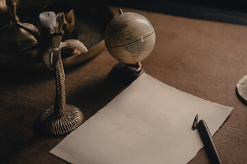 Ink pen and blank sheet on antique wooden desk. An empty white page with an old calligraphy ink pen...