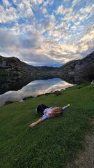 person on the mountain in front of lake