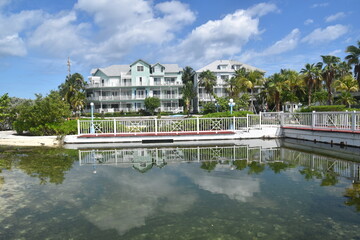 A cute colonial inspired hotel exterior design with pastel  colours by the Caribbean sea in Bahamas