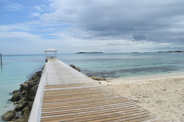 A cute colonial inspired hotel exterior design with pastel  colours by the Caribbean sea in Bahamas