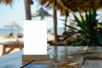 Label the menu frame in a bar with white sheet paper tent card on table with beach background for adding text or image