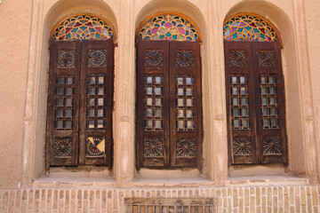 Obraz premium wooden door, Ancient wooden door, Medieval window, Ornate, Glass pattern, Medieval arches featured clay, Wooden doors with ornate glass patterns, Brick, Persia, Yazd Iran