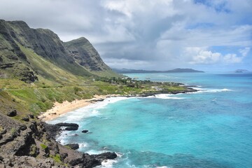 The stunning azure turquoise blue Pacific Ocean off of Oahu Island's lush coast on Hawaii