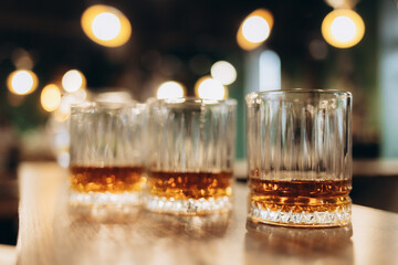 Close-up selective focus a flight of whiskies. Four different whiskies in whisky tasting glasses.