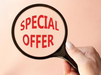 Special offer symbol. Concept word Special offer on wooden blocks. Businessman hand. Beautiful pink...