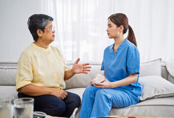 Fototapeta premium woman in a yellow shirt is talking to a woman in a blue uniform