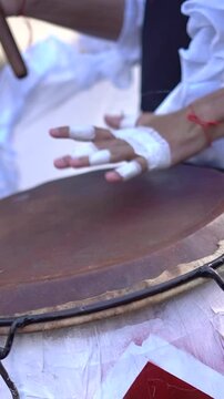 Man playing candombe drum in carnival celebration in the streets of San Telmo.