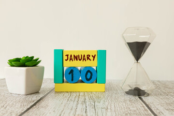 A close-up of a wooden calendar block showing January 10.