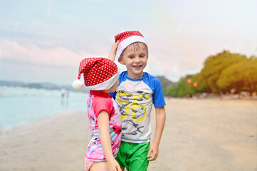 kids in Santa hat on the beach