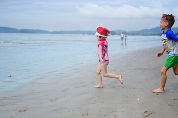 kids in Santa hat on the beach