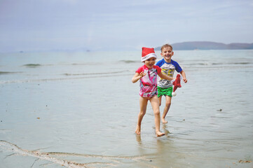 kids in Santa hat on the beach