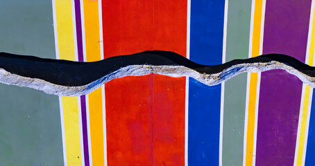 A colorful wall with lgbtq rainbow stripes