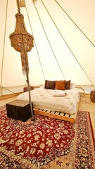 A luxury glamping hotel tipi tent experince with cosy details and interior design 