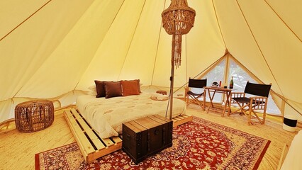 A luxury glamping hotel tipi tent experince with cosy details and interior design 