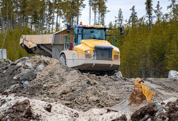 Dump truck driving on a forest construction site