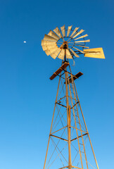 Old windmill and the moon, water wind pump, Namibia, Africa