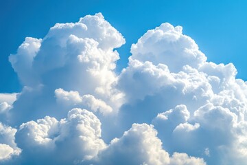 Close-up of fluffy white cumulus clouds against a vivid blue sky