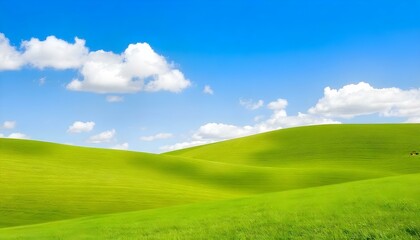 Obraz premium The image showcases a vast expanse of rolling green hills under a bright blue sky. The grass is lush and vibrant, creating a fresh, inviting landscape. The gentle curves of the hills add a sense of de