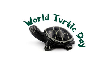 Turtle figurine with text ' World Turtle Day ' isolated on white background. May 23. Save the turtles.