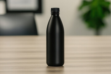 A black bottle sits on a wooden table