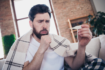 Photo of sick ill man staying home feeling unwell suffer covid19 symptom sitting on sofa living...