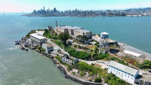 Rotating panning shot of Alcatraz Island, with San Francisco and the Oakland Bay Bridge in the background.