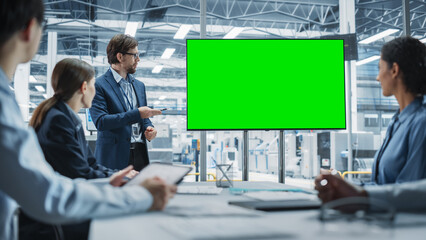 Electronics Factory Office Meeting: Caucasian Male CEO Presenting Innovative High-Tech Device On TV...