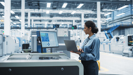 Hispanic Female Engineer Using Laptop To Control Soldering Jet Printer On Electronics Factory....