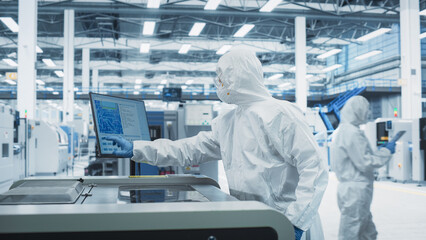 Printed Circuit Board Production At Electronics Factory: Technician In Sterile Suit Using Soldering...