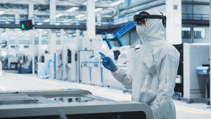 Sterile Coverall Wearing Engineer Uses Augmented Reality Headset to Interact With Models of Silicon...