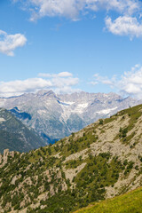 Panorama of Italian Alps with blue sky and cloud. Calm landscape, tranquil scenic view.
