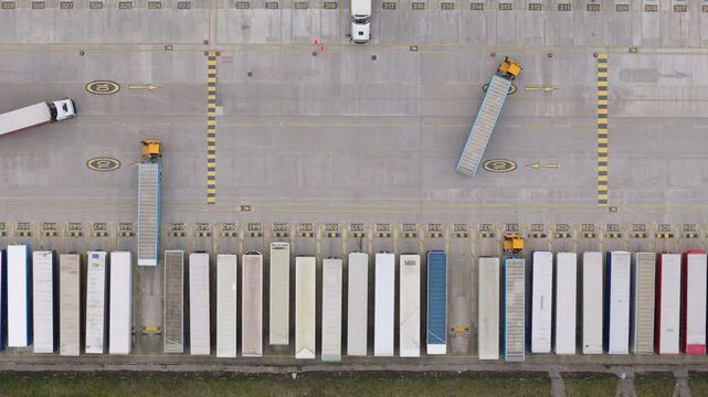 Top down aerial view of trucks at distribution center in the United Kingdom. Logistics and delivery concept.