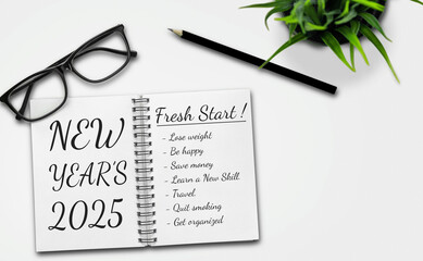 Fototapeta premium 2025 Happy New Year Resolution Goal List and Plans Setting - Business office desk with notebook written about plan listing of new year goals and resolutions setting. Change and elation concept.