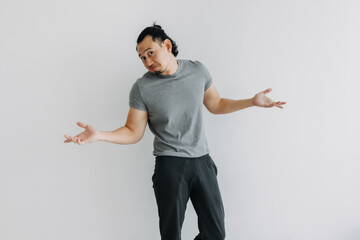 Never mind, no matter, not care. Full body of Asian man isolated on white.
