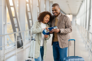 Travel Insurance Concept. Portrait Of Happy Young African American Couple Waiting For Flight At...