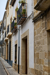 Obraz premium Historic European stone buildings with decorative iron balconies on a narrow street