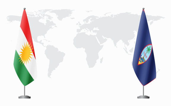 Kurdistan and Guam flags for official meeting against background of world map.